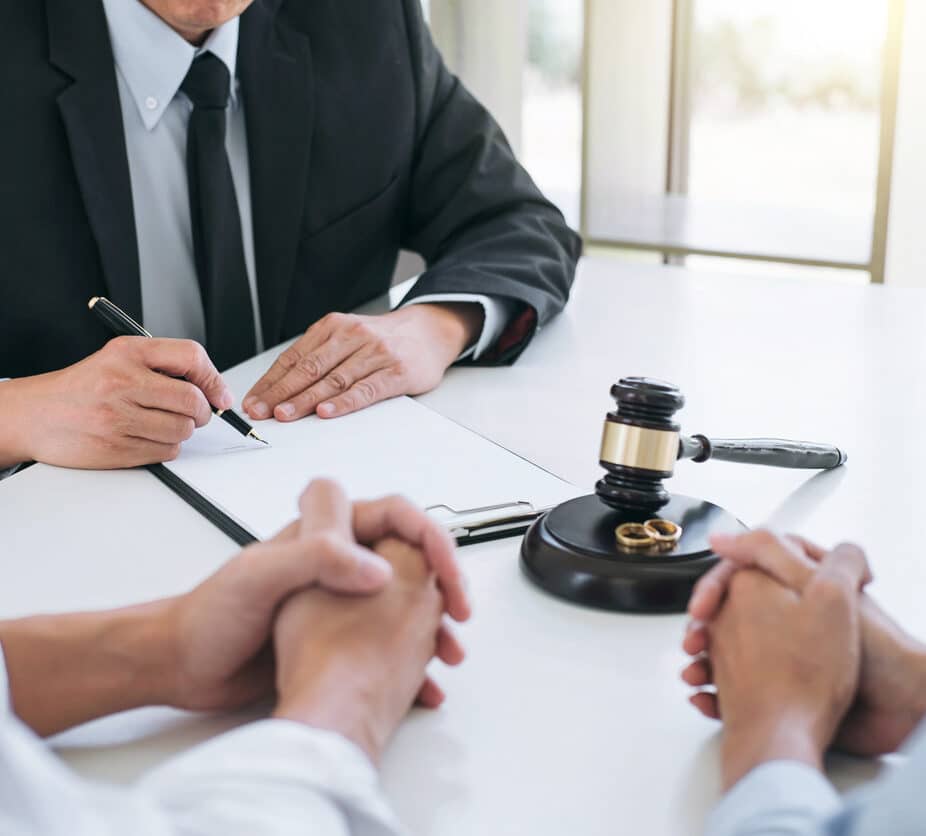 Agreement prepared by lawyer signing decree of divorce (dissolution or cancellation) of marriage, husband and wife during divorce process with male lawyer or counselor and signing of divorce contract.