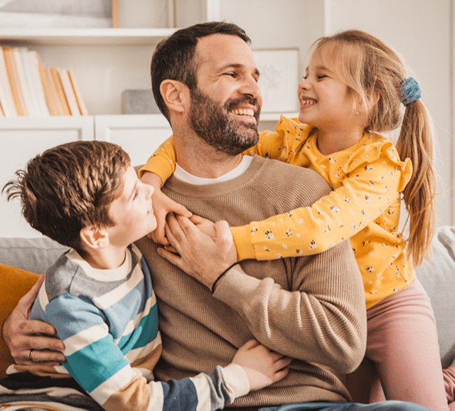 Loving father holding her son and daughter on his arms
