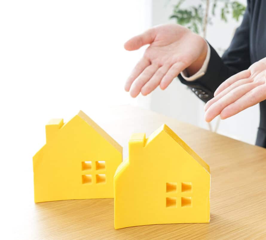 Lawyer showing two equal plastic houses